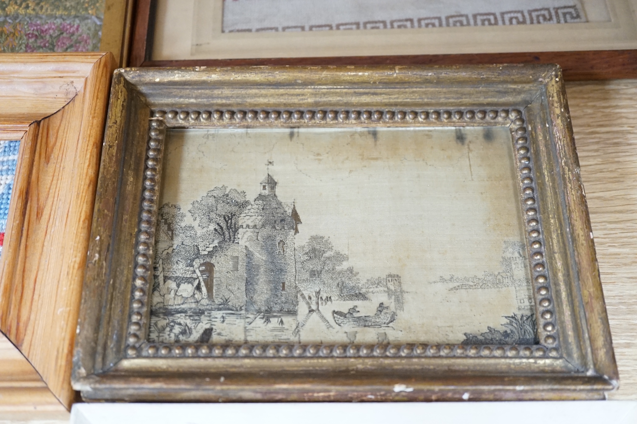 From the Studio of Fred Cuming. Six needlework embroideries including an alphabet sampler, Study of oak leaves, and 19th century landscapes, largest 23 x 29. Condition - varies, poor to fair